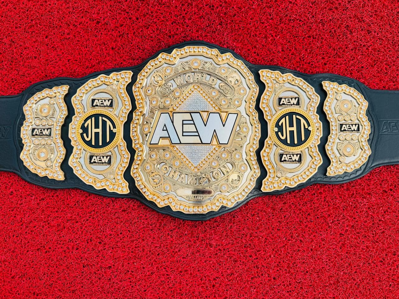 Stone-Set World championship belt laid flat, showing the fully jewelled gold centre plate and four side plates